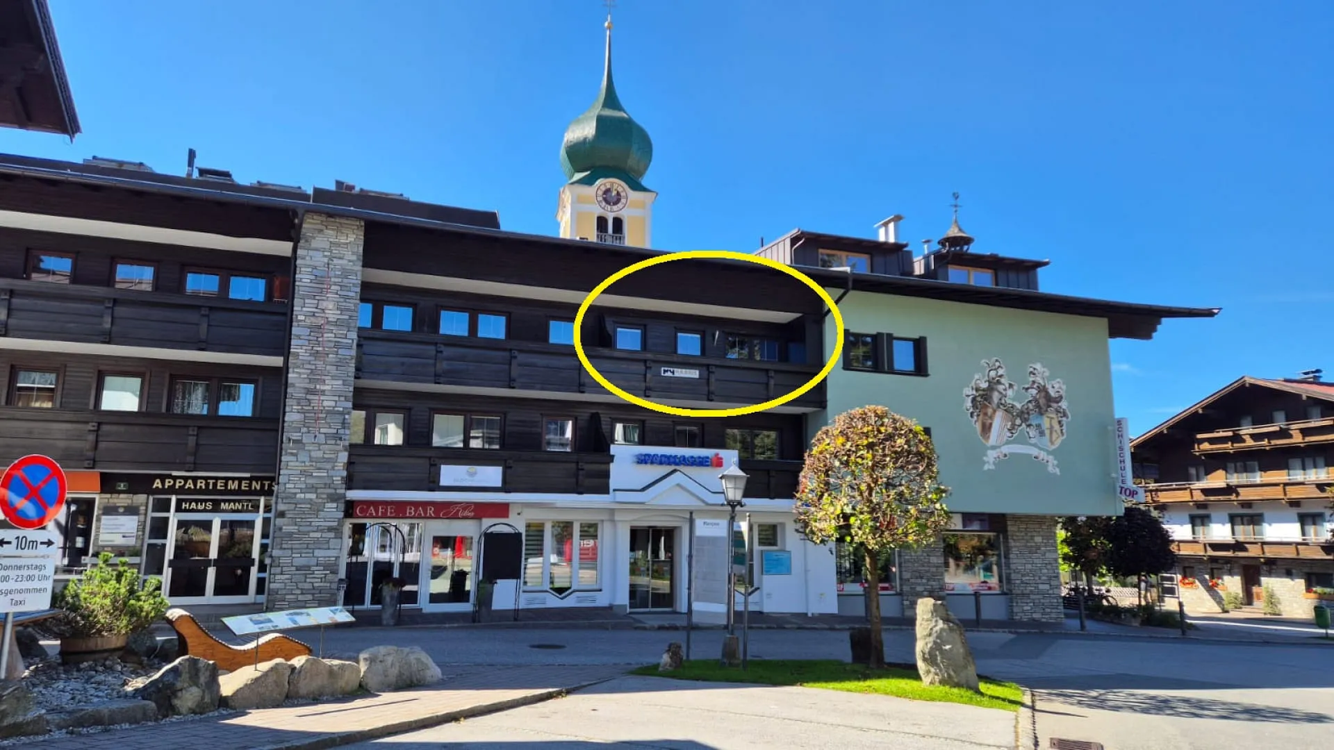 Ansicht des Appartement Harrie Lage mit einer auffälligen Uhrturm im Hintergrund.